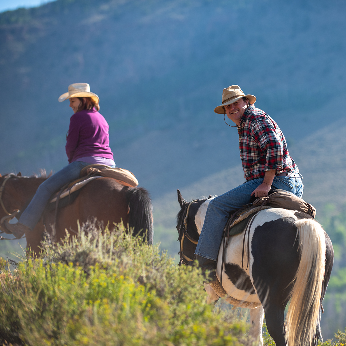 horsepg-ride-dude Man on horseback enjoying the views with family