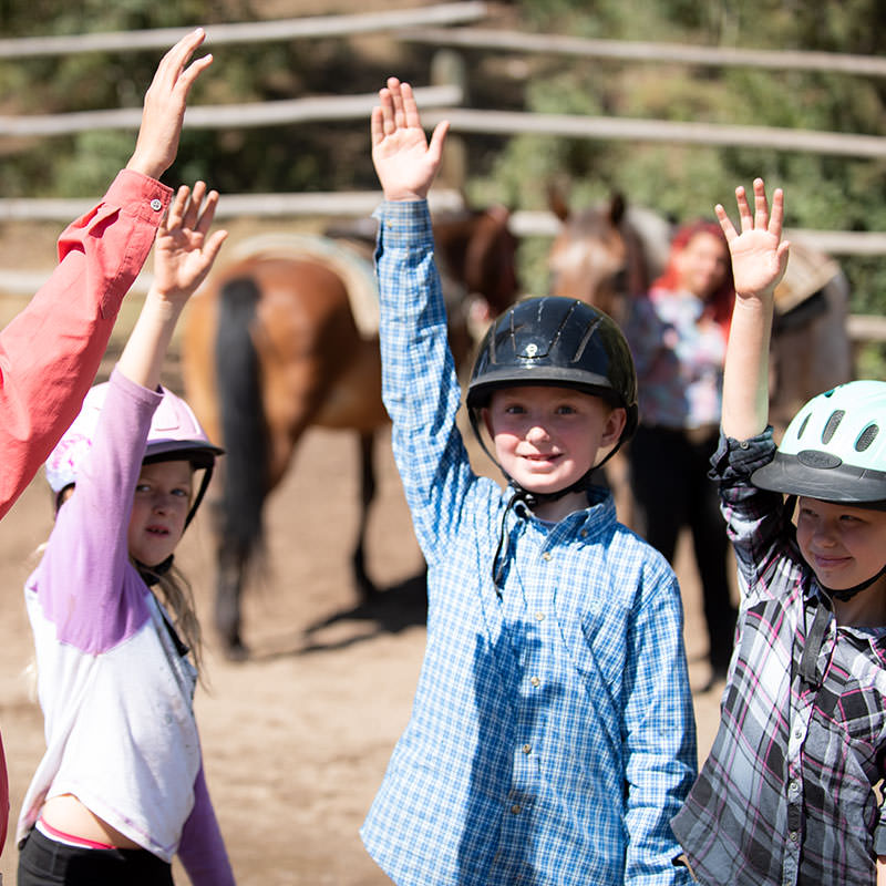 Little girls happily participating in riding program